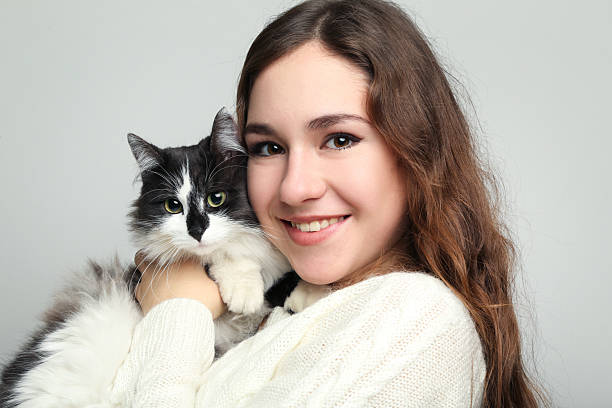 istock Beautiful young woman holding cat on grey background 2208847309