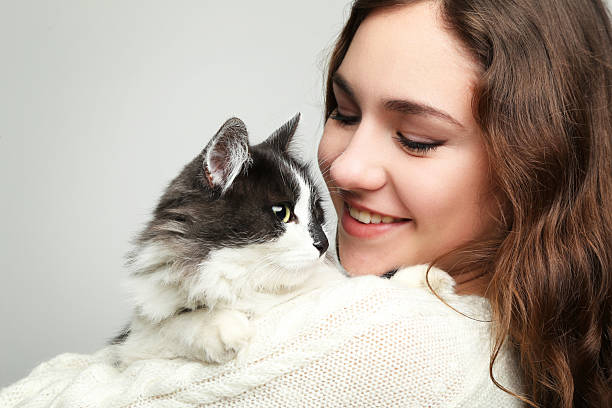 istock Beautiful young woman holding cat on grey background 2208848482