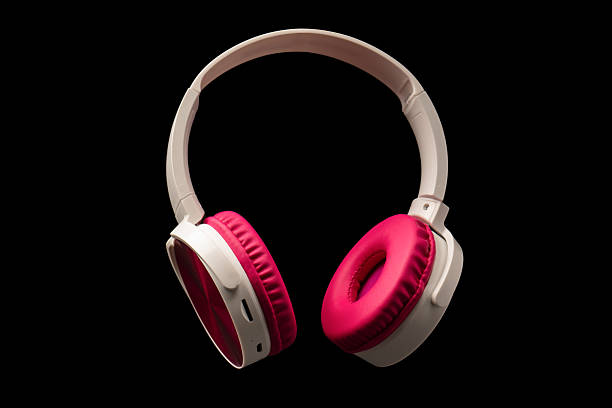 istock Pink and white headphones isolated on a black background. 2208851895