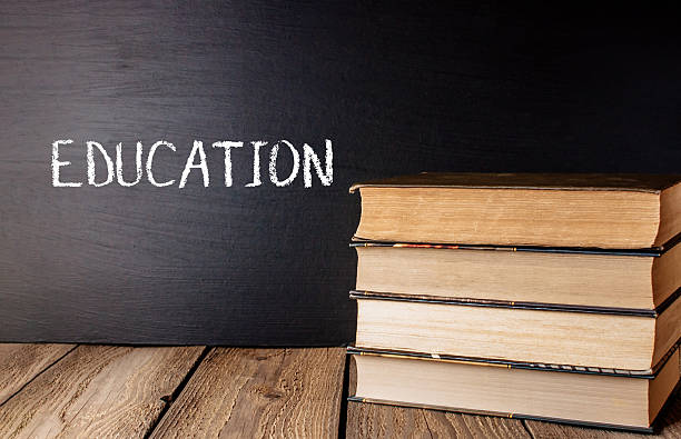 istock Stack of books with the word Education written on a chalkboard 2208855001