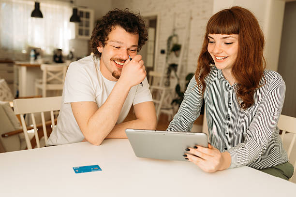 istock Young people shopping on line in a cozy home 2208856214
