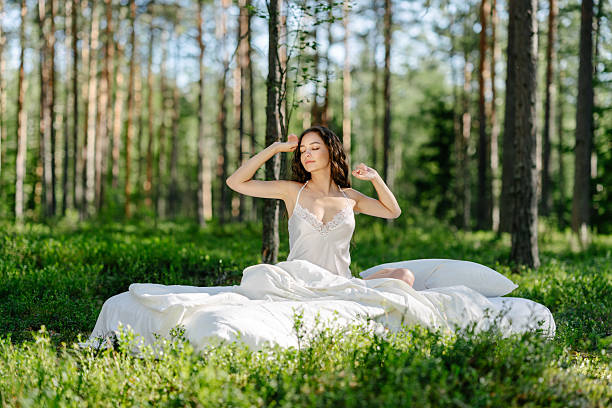 istock Girl wakes up in a summer forest 2208857913