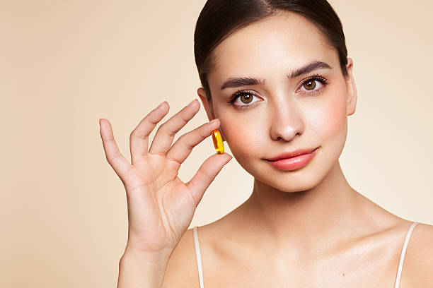 istock Beautiful Girl With Pill With Cod Liver Oil Omega-3 2208858014