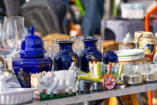 istock A colorful array of ceramics and glassware on display at a flea market. The collection includes navy blue vases, decorative animal figurines, and various kitchenware, creating a colorful and eclectic scene. 2208858258