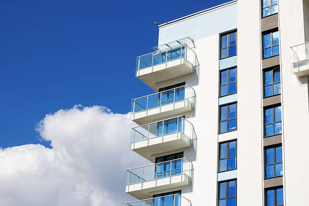 istock Urban design tower block with blue facade, numerous windows, and balconies 2208861224
