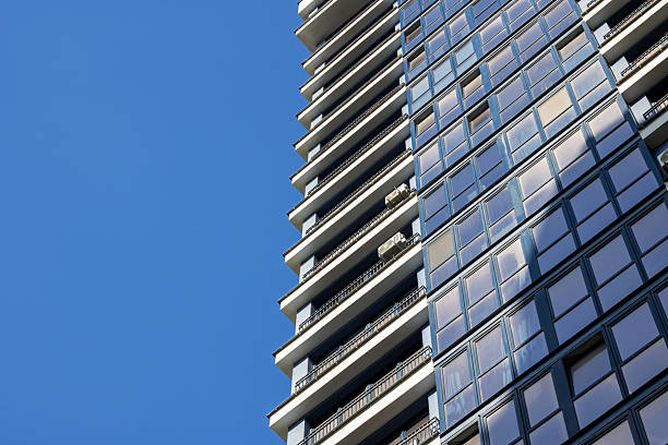 istock Skyscraper towering above urban design, framed by clear blue sky 2208861266