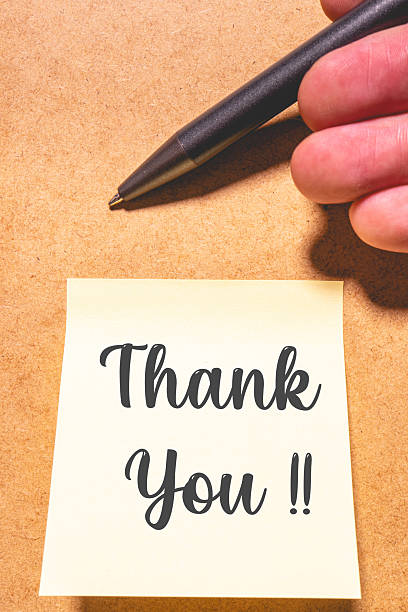 istock A thank you note with a pen, on a brown background. 2208862091