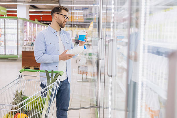 istock Customer Choosing Dairy Products in Supermarket Refrigerator Display Case 2208865051