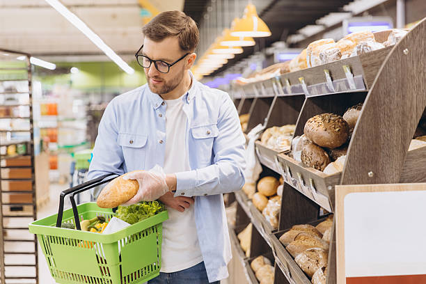 istock Customer wearing gloves choosing bread in supermarket bakery section 2208866245