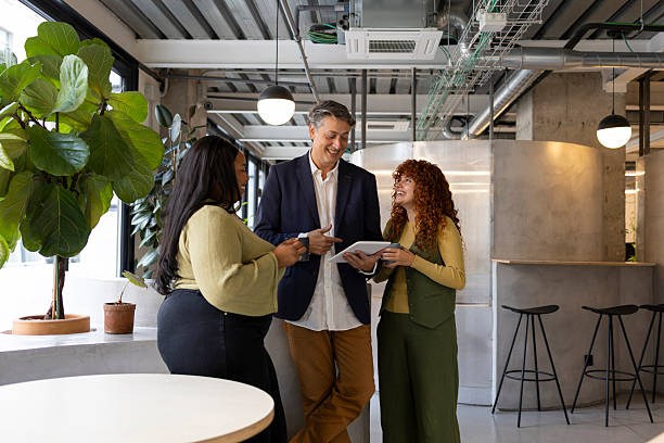 istock Multi-ethnic team collaborating on digital tablet in modern coworking space 2208866805