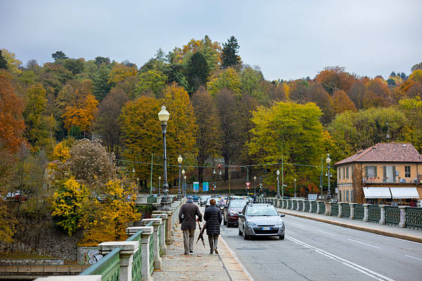 Turin, Italy - Nov 09 2021: People walking on Ponte Isabella overlooking the Po River