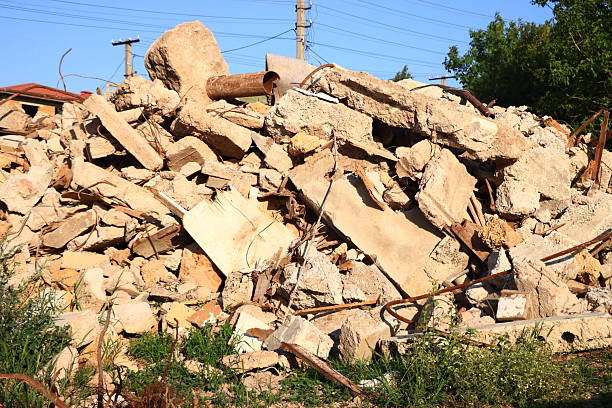 Pile of concrete rubble debris at a construction site with exposed rebar.