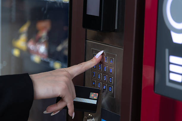 istock Woman selects item from vending machine in public space during daytime 2208872860