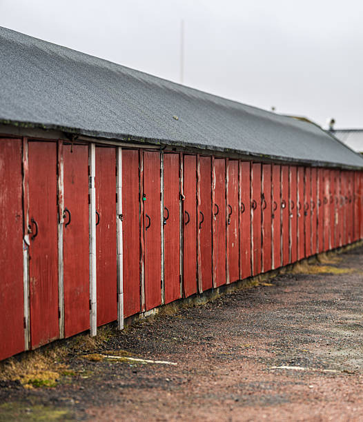 istock weathered red wooden doors of storage facility or small garages.. 2208876470
