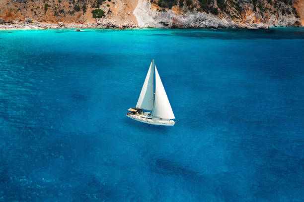 istock White sailboat floating in turquoise sea aerial view 2208877548