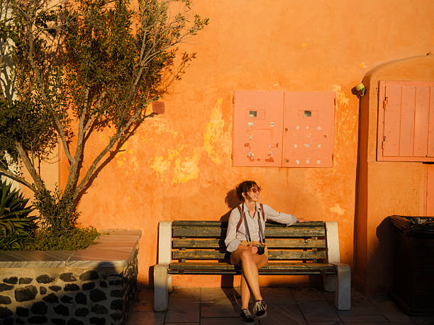 Woman sunbathing on the bench during exploration on Greek island