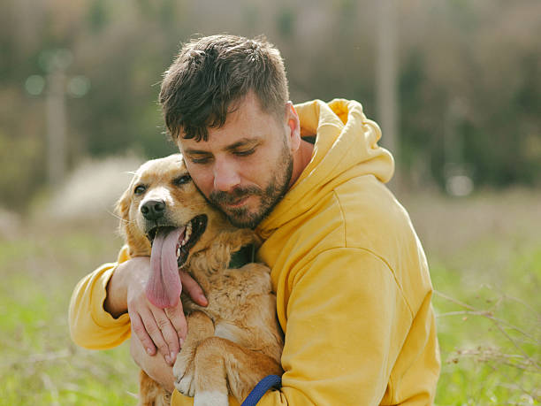 istock Guy and his dog, golden retriever, nature 2208881130