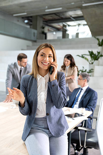 istock Smiled and happy businesswoman using her smart phone in office 2208882298