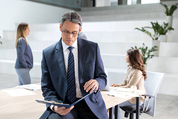 istock Mature adult businessman dealing with paperwork 2208883321