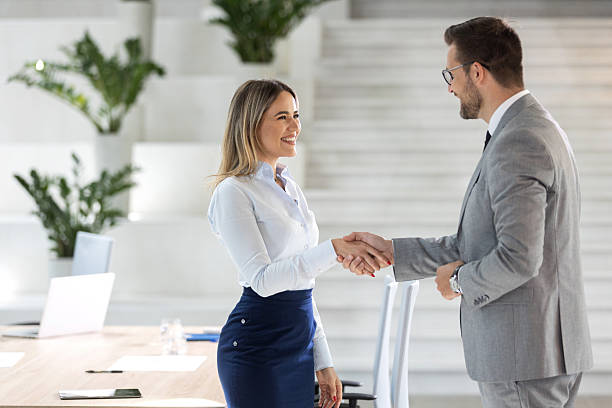 istock Business people shaking hands inside modern office 2208883541