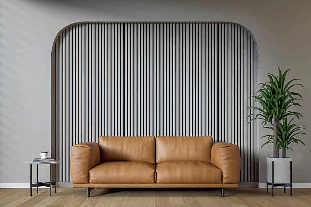 istock A modern, minimalist living room with a warm brown leather sofa set against a light gray wooden slat accent wall with copy space, surrounded by an arched muted teal blue (green) background and decoration 2208885062