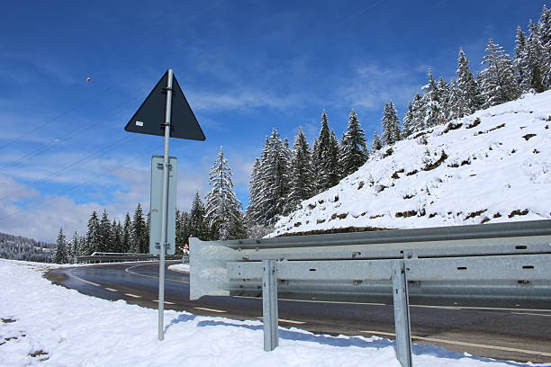 A snowy mountain with a sign. Snow. Outdoor. Sky. Nature. Ski slope
