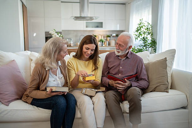 istock Daughter surprising senior parents with a gift at home 2208887332