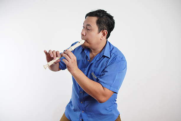 Little boy playing the flute