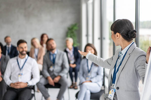 istock Audience Reacting Positively to Speaker in Corporate Setting 2208896666
