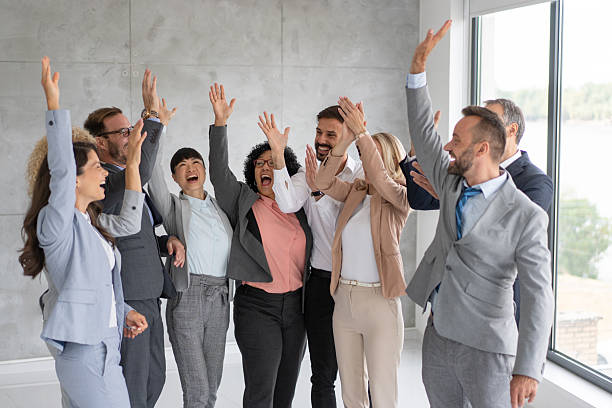 istock Cheerful professionals celebrating achievements together 2208896742
