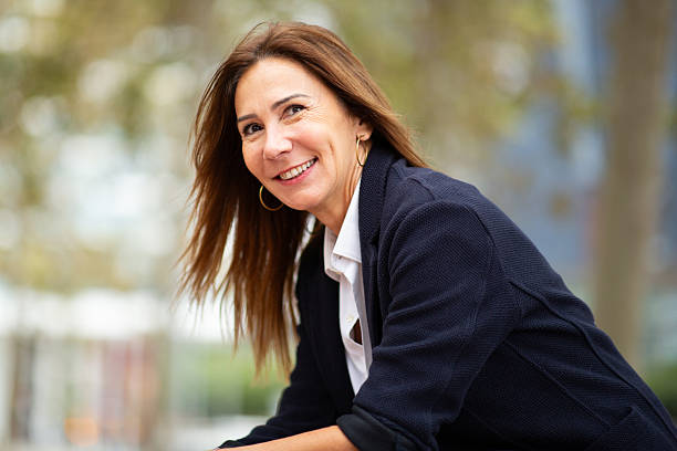 istock confident woman sitting outdoors in urban park 2208897829