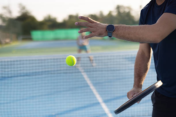 istock Tennis player tosses a ball, preparing a powerful serve shot. 2208898596