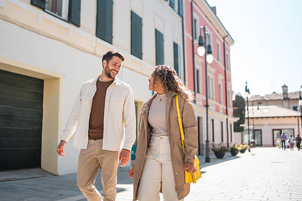 istock Young Diverse Couple Smiling While Strolling in Bright Daylight Wearing Casual Neutral Outfits 2208909462