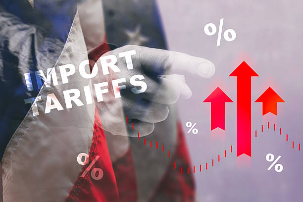 istock IMPORT TARIFFS with a pointing hand, rising red arrows, and percentage symbols against a US flag backdrop, highlighting the economic effects of trade policies. 2208910582
