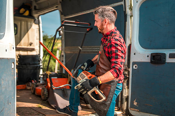 istock Gardener in Apron and Protective Gloves Unloading Gardening Tools from Van in Garden Center 2208911628