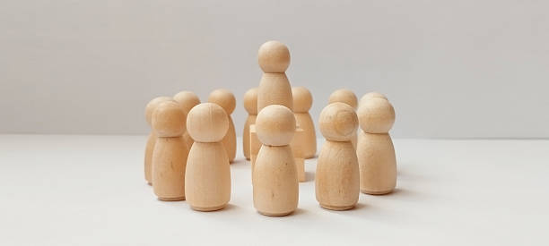 istock Group discussion among wooden figures minimalist setting conceptual art neutral background close-up leadership dynamics 2208911683