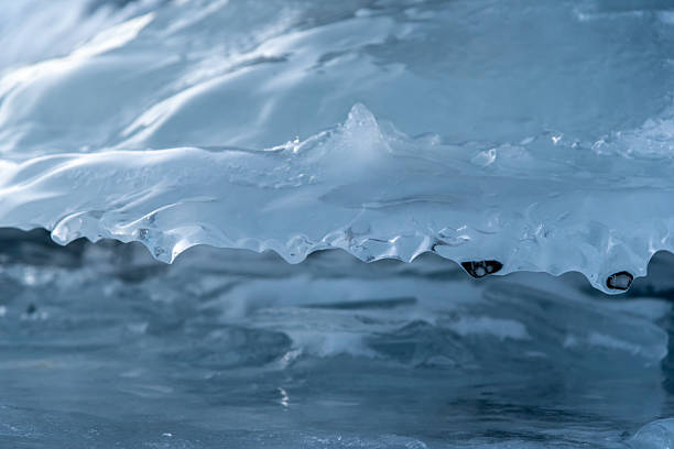 istock Ice formations seen in winter season time with snow capped mountains in distant background. Frozen lake, icy mushroom formations. Taken in British Columbia near Alaska, Yukon Territory. 2208915539