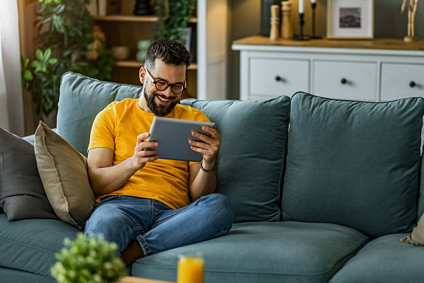 istock Man relaxing at home and using digital tablet at home. 2208917412