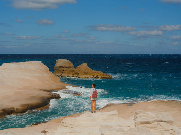 istock Woman exploring white cliffs on Sarakiniko beach in Greece 2208917945