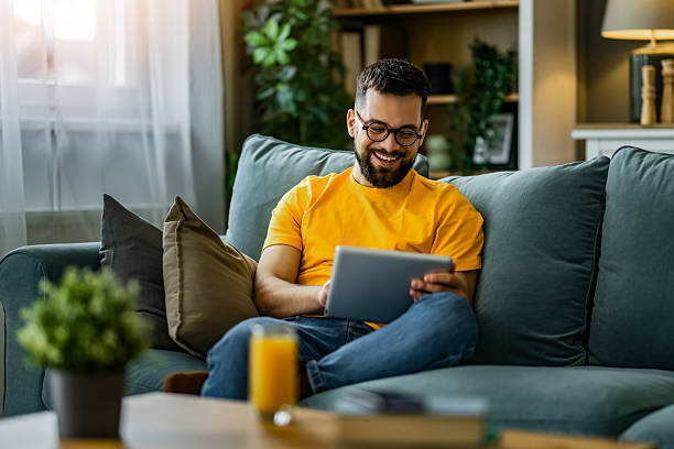 istock Man relaxing at home and using digital tablet at home. 2208918883