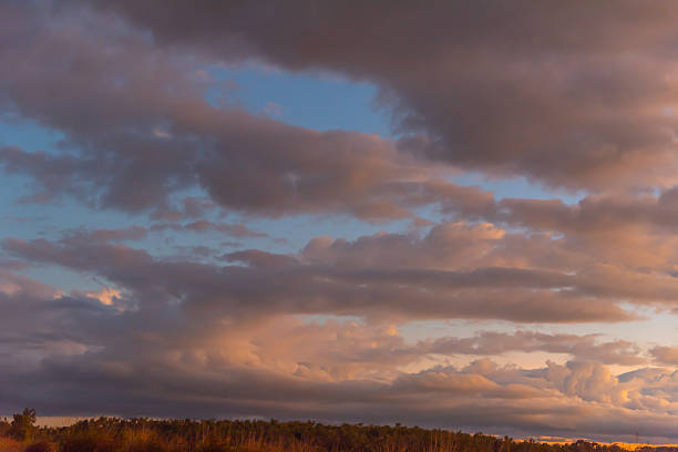 Stunning sunset scene in Australia with unreal, calming clouds in peaceful, idyllic landscape view in Queensland.