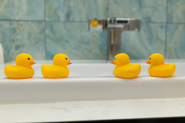 istock Adorable and Cute Rubber Ducks in an Amusing Bathtub Setting Making for a Lovely Scene 2208921051