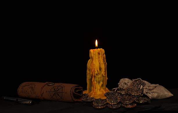 istock Antique candle surrounded with doubloons coins and leather pouch 2208926994