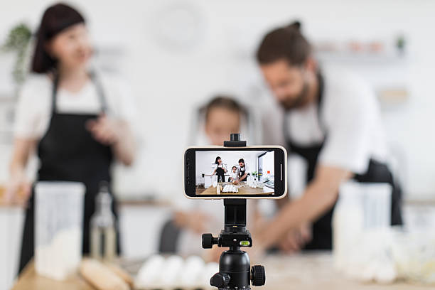 istock Family blogging chefs showcasing dough preparation in modern kitchen 2208927769