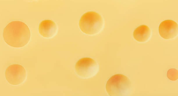 istock Textured Emmental cheese as a background Swiss holey maasdam cheese wallpaper. Pattern. High resolution image 2208932320