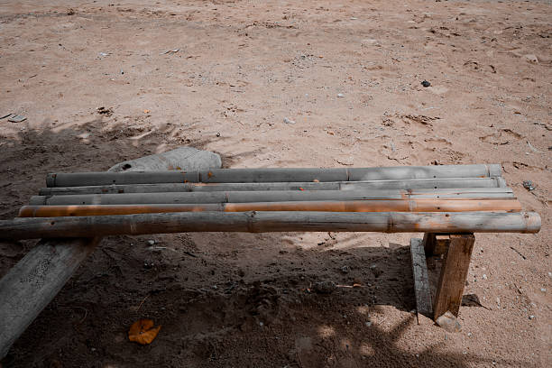 A simple bamboo bench stands in an arid environment, a rustic touch in a natural setting.
