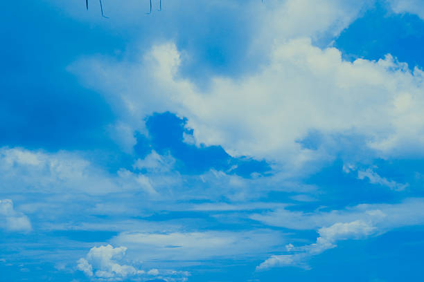 A breathtaking view of a vibrant blue sky adorned with soft, white clouds.
