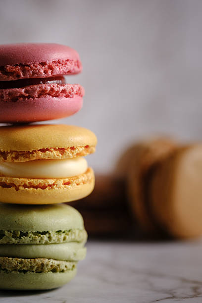 istock Vertical close up of 3 vividly colored stacked macaroons. 2208935666