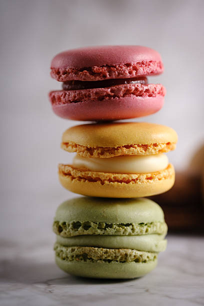 istock Vertical close up of 3 vividly colored stacked macaroons. 2208935668