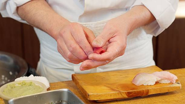 istock The hands of a chef preparing sushi 2208936605